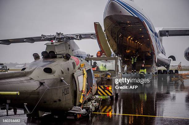 Belgian helicopters equiped for deployment to Mali are loaded onto a Russian made Ilyushin aircraft on January 29, 2013 at the Melsbroek military...