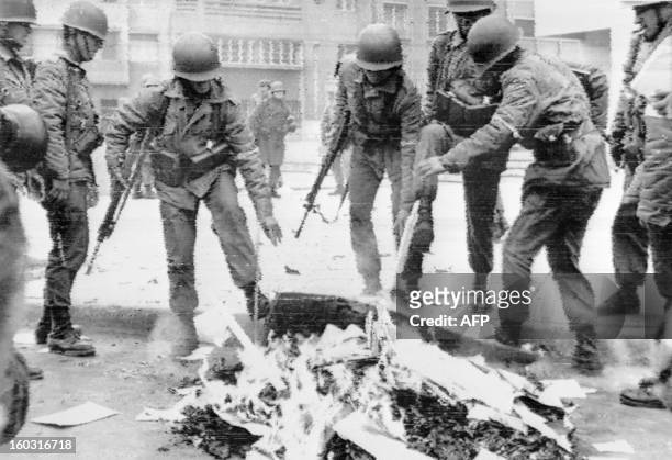 Chilean soldiers burning Marxist books in the capital city during the military coup, Santiago, 26 September 1973. Presidente Salvador Allende died in...