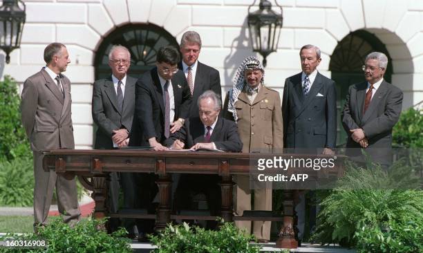 Israeli Foreign Minister Shimon Peres signs the historic Israel-PLO Oslo Accords on Palestinian autonomy in the occupied territories on September 13,...