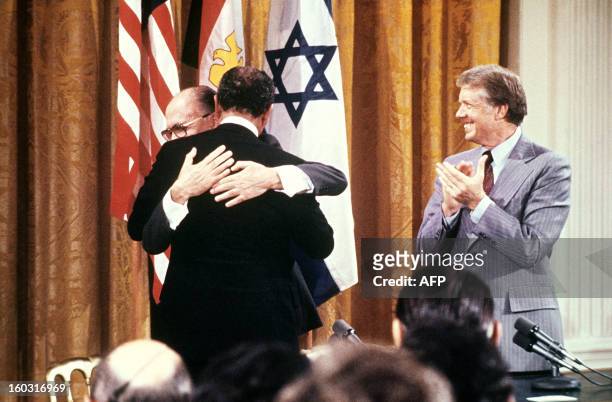 Egyptian President Anwar al-Sadat and Israeli Premier Menachem Begin embrace each other, on September 17 after signing a peace agreement in the East...