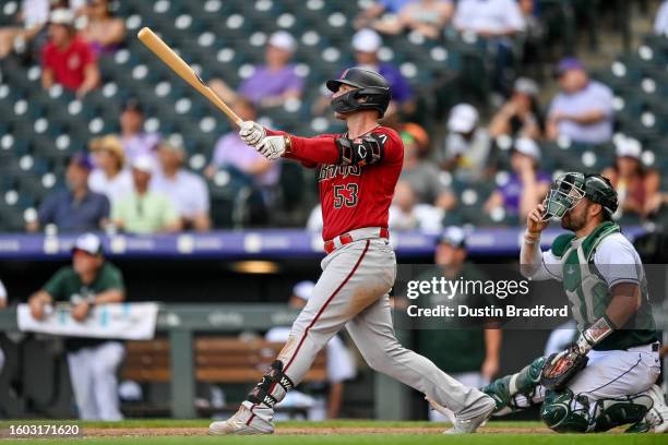 Christian Walker of the Arizona Diamondbacks hits an eighth inning two-run home run against the Colorado Rockies at Coors Field on August 16, 2023 in...