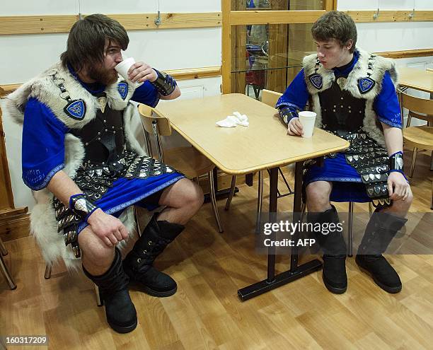 Participants dressed as Vikings enjoy as hot drink as they prepare to participate in the annual Up Helly Aa festival in Lerwick, Shetland Islands on...
