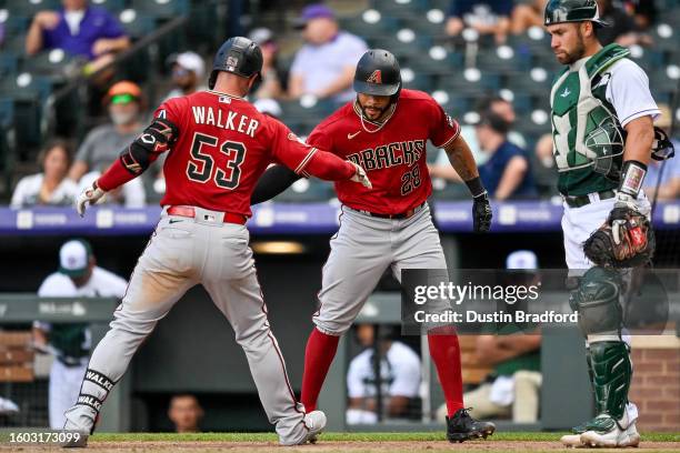 Christian Walker of the Arizona Diamondbacks celebrates with Tommy Pham after hitting an eighth inning two-run home run against the Colorado Rockies...