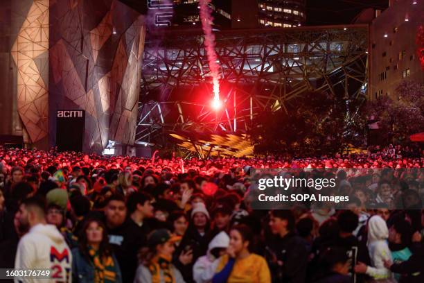 Flare falls into the crowd as Matildas fans watch the game at Federation Square during the Women's World Cup semifinal in Melbourne. Australian and...