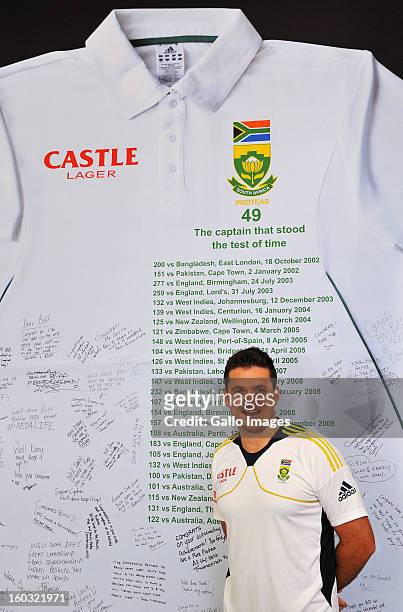 Graeme Smith of South Africa poses next to a sign displaying messages of congratulations from fans ahead of Graeme Smith's 100th Test as captain at...