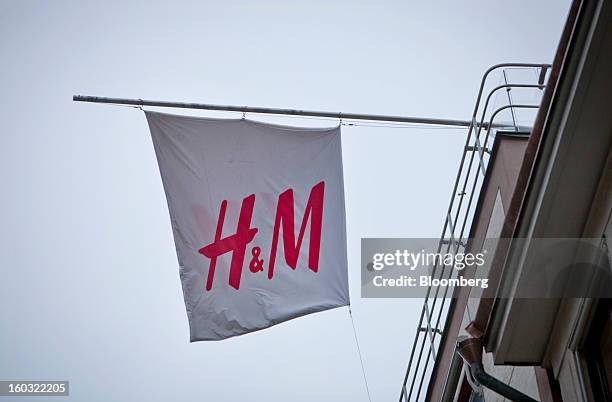 Logo sits on display on a banner hanging from the roof of a Hennes & Mauritz AB store in Stockholm, Sweden, on Tuesday, Jan. 29, 2013. Hennes &...