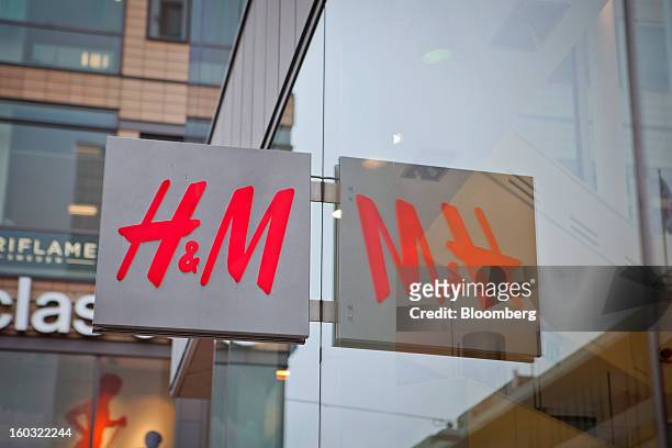 Logo hangs outside a Hennes & Mauritz AB store in Stockholm, Sweden, on Tuesday, Jan. 29, 2013. Hennes & Mauritz AB, Europe's second-largest clothing...
