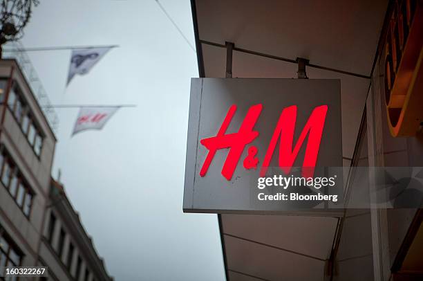 Logo hangs outside a Hennes & Mauritz AB store in Stockholm, Sweden, on Tuesday, Jan. 29, 2013. Hennes & Mauritz AB, Europe's second-largest clothing...