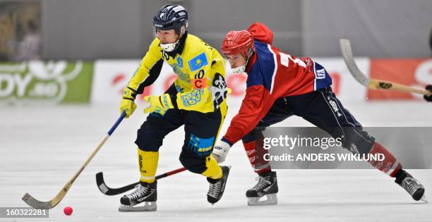 Kazakhstan's Rauan Issaliev and Norway's Robin Cras vie during the Bandy World Championship match between Kazakhstan and Norway in Vanersborg,...