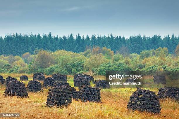 peat stacks in ireland - peat stock pictures, royalty-free photos & images