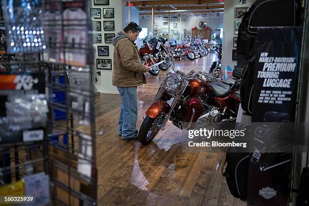 Display for Harley-Davidson Inc. Luggage stands at right while a customer looks at a motorcycle on the showroom floor at the Dudley Perkins Co....