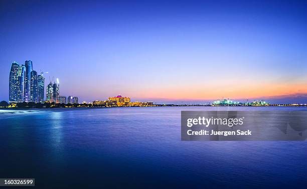 beautiful view of a city and water in abu dhabi - abu dhabi skyline stock pictures, royalty-free photos & images