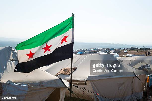 free syrian flag in refugee camp (atmeh, syria) - refugee camp stock pictures, royalty-free photos & images
