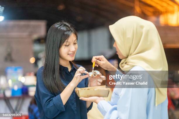 teenagers enjoying street food - indonesia street stock pictures, royalty-free photos & images