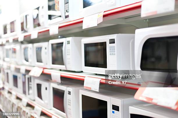 microwave oven sale. - appliance shop stock pictures, royalty-free photos & images