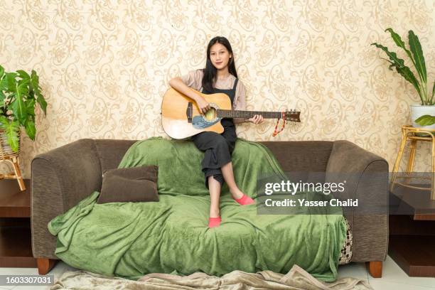 portrait of beautiful teen girl playing guitar - musician portrait stock pictures, royalty-free photos & images