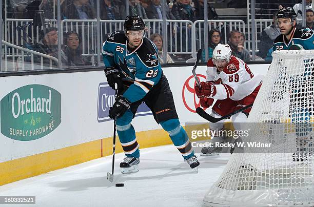 Michal Handzus of the San Jose Sharks protects the puck against Mikkel Boedker of the Phoenix Coyotes at the HP Pavilion on January 24, 2013 in San...