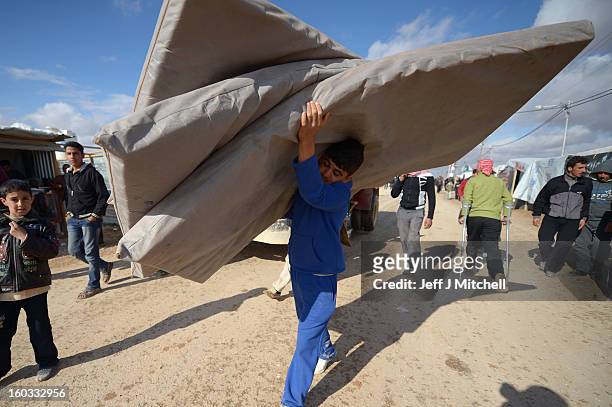 Syrian refugees go about their daily business in the Za’atari refugee camp on January 29, 2013 in Mafraq, Jordan. Record numbers of refugees are...
