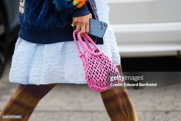 Guest wears a pale blue embossed pattern puffy knees dress, a navy blue denim with white and yellow embroidered pattern oversized bomber coat, a pink...