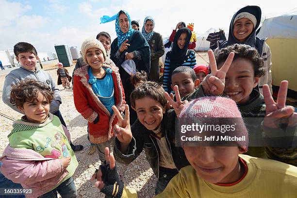 Young children gesture as Syrian refugees go about their daily business in the Za’atari refugee camp on January 29, 2013 in Mafraq, Jordan. Record...
