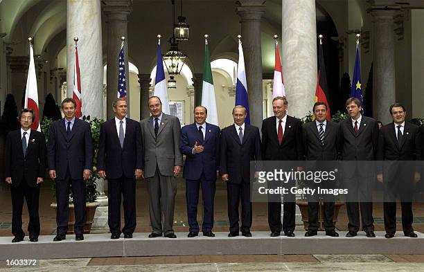 Leaders of the Group of Eight nations pose for a family photo July 22, 2001 at the G8 summit in Genoa, Italy. Left to right are Japanese Prime...