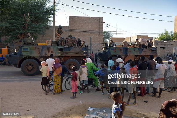 French military convoy crosses on January 29, 2013 Timbuktu after French-led troops freed the northern desert city on January 28 from Islamist...
