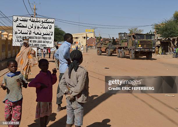 French military convoy crosses on January 29, 2013 Timbuktu after French-led troops freed the northern desert city on January 28 from Islamist...