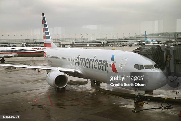 New American Airlines 737-800 aircraft featuring a new paint job with the company’s new logo sits at a gate at O'Hare Airport on January 29, 2013 in...