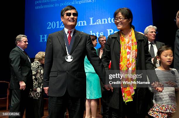 Chinese human rights activist Chen Guangcheng stands with his wife Yua Weijing following a ceremony where he was presented the Tom Lantos Human...