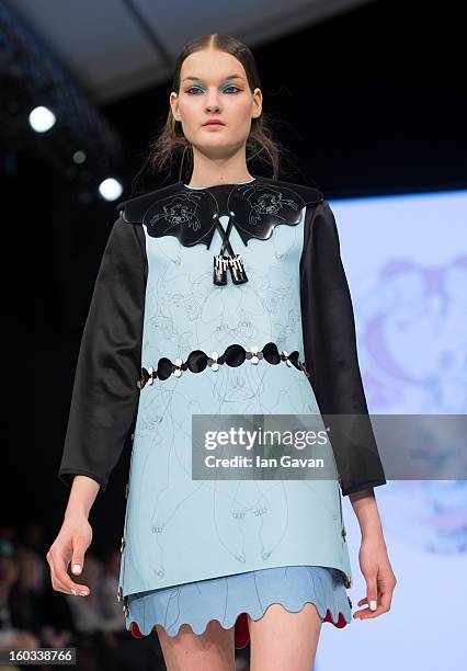 Model walks the runway wearing designs by winner Minju Kim during the H&M Design Award at Mercedes-Benz Stockholm Fashion Week Autumn/Winter 2013 at...