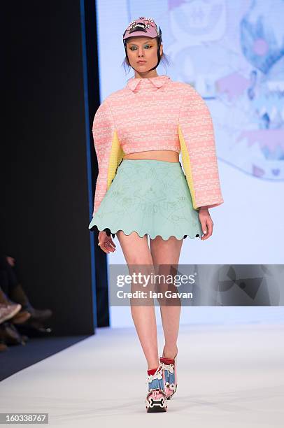Model walks the runway wearing designs by winner Minju Kim during the H&M Design Award at Mercedes-Benz Stockholm Fashion Week Autumn/Winter 2013 at...