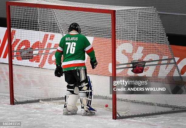 Belarus goalkeeper Dmitry Sergeev picks out the ball from the goal during the Bandy World Championship match between Sweden and Belarus in...