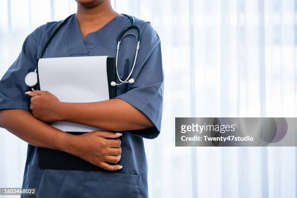 mid-section of a colored nurse working in the hospital ward - medical ward stock pictures, royalty-free photos & images
