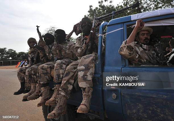 Soldiers of Malian Colonel Alaji Ag Gamou sit on a pick-up truck as they enter on January 29, 2013 Ansongo, a town south of the northern Malian city...