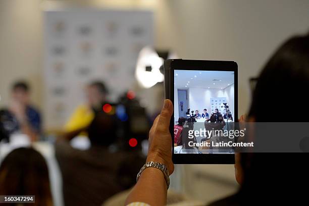 Woman takes a picture during the first official training season of the team, who will represent Brazil in the Olympic Games Rio 2016, at Maria Lenk...