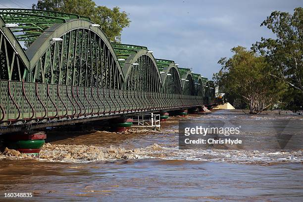 The sun rises over flooded the Burnett river as parts of southern Queensland experiences record flooding in the wake of Tropical Cyclone Oswald on...