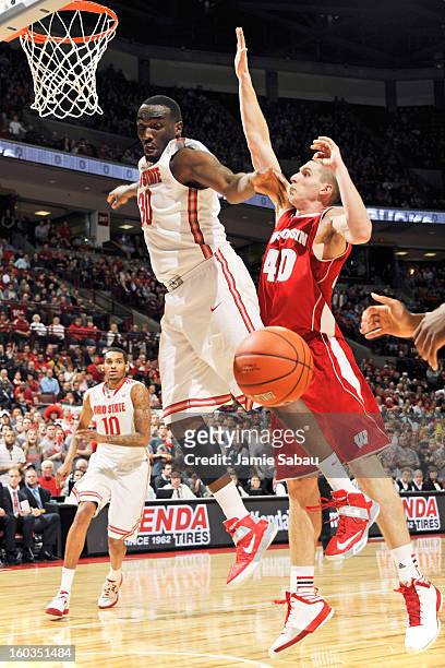 Evan Ravenel of the Ohio State Buckeyes has the ball stripped away by Jared Berggren of the Wisconsin Badgers in the second half on January 29, 2013...