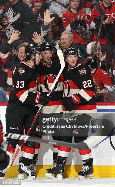 Jim O'Brien of the Ottawa Senators celebrates his second period goal with team mates Mika Zibanejad and Erik Condra during an NHL game against the...