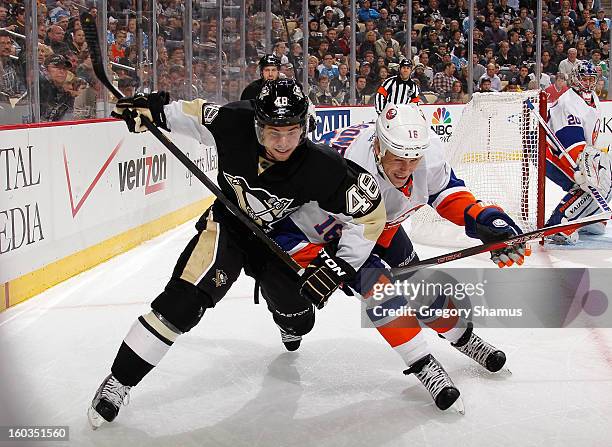 Tyler Kennedy of the Pittsburgh Penguins battles for position against Marty Reasoner of the New York Islanders on January 29, 2013 at Consol Energy...