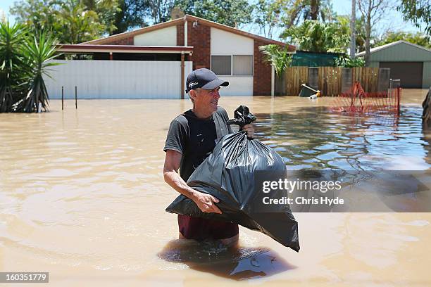 Residents collect belongings from their homes their as parts of southern Queensland experiences record flooding in the wake of Tropical Cyclone...