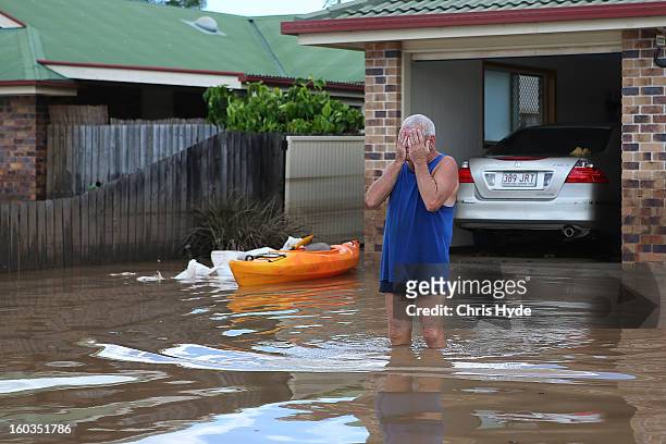 Residents reacts to the damage to his house as parts of southern Queensland experiences record flooding in the wake of Tropical Cyclone Oswald on...