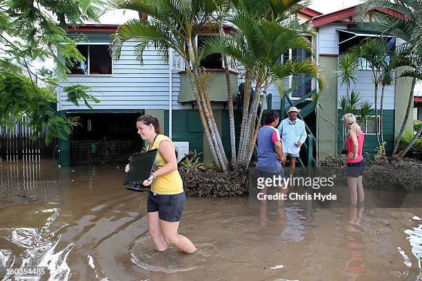 Residents collect belongings from their homes as parts of southern Queensland experiences record flooding in the wake of Tropical Cyclone Oswald on...