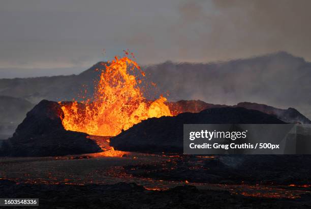 scenic view of lava with volcano against sky - active volcano stock pictures, royalty-free photos & images