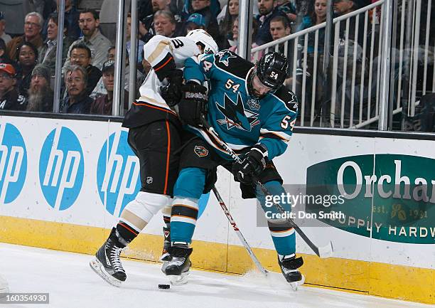 Nick Petrecki of the San Jose Sharks battles for the puck against Nick Bonino of the Anaheim Ducks during an NHL game on January 29, 2013 at HP...