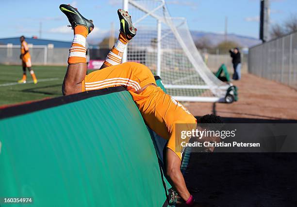 Giles Barnes of the Houston Dynamo falls over the end boards during The Desert Friendlies Presented By FC Tucson against the San Jose Earthquakes at...