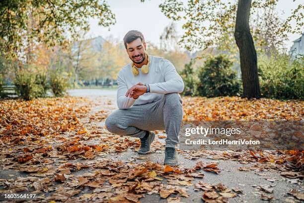 man checks data on a fitness tracker - body image stock pictures, royalty-free photos & images