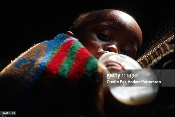 An infant infected by HIV rests June 15, 2000 at a clinic for HIV or AIDS infected mothers in Khayelitsha, a poor township outside Cape Town, South...
