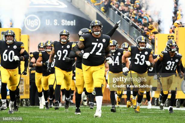 The Pittsburgh Steelers offensive line led by Zach Banner runs out of the tunnel prior to an NFL game against the Detroit Lions at Heinz Field on...