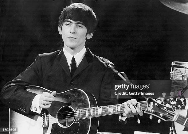 Beatles guitarist and singer George Harrison performs December 3, 1963 during a concert. Conflicting reports were released July 23, 2001 regarding...