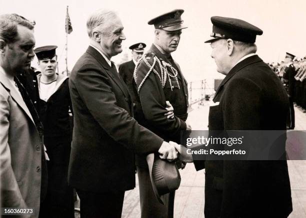 American President Franklin D Roosevelt shaking hands with British Prime Minister Winston Churchill on board the HMS Prince of Wales during their...